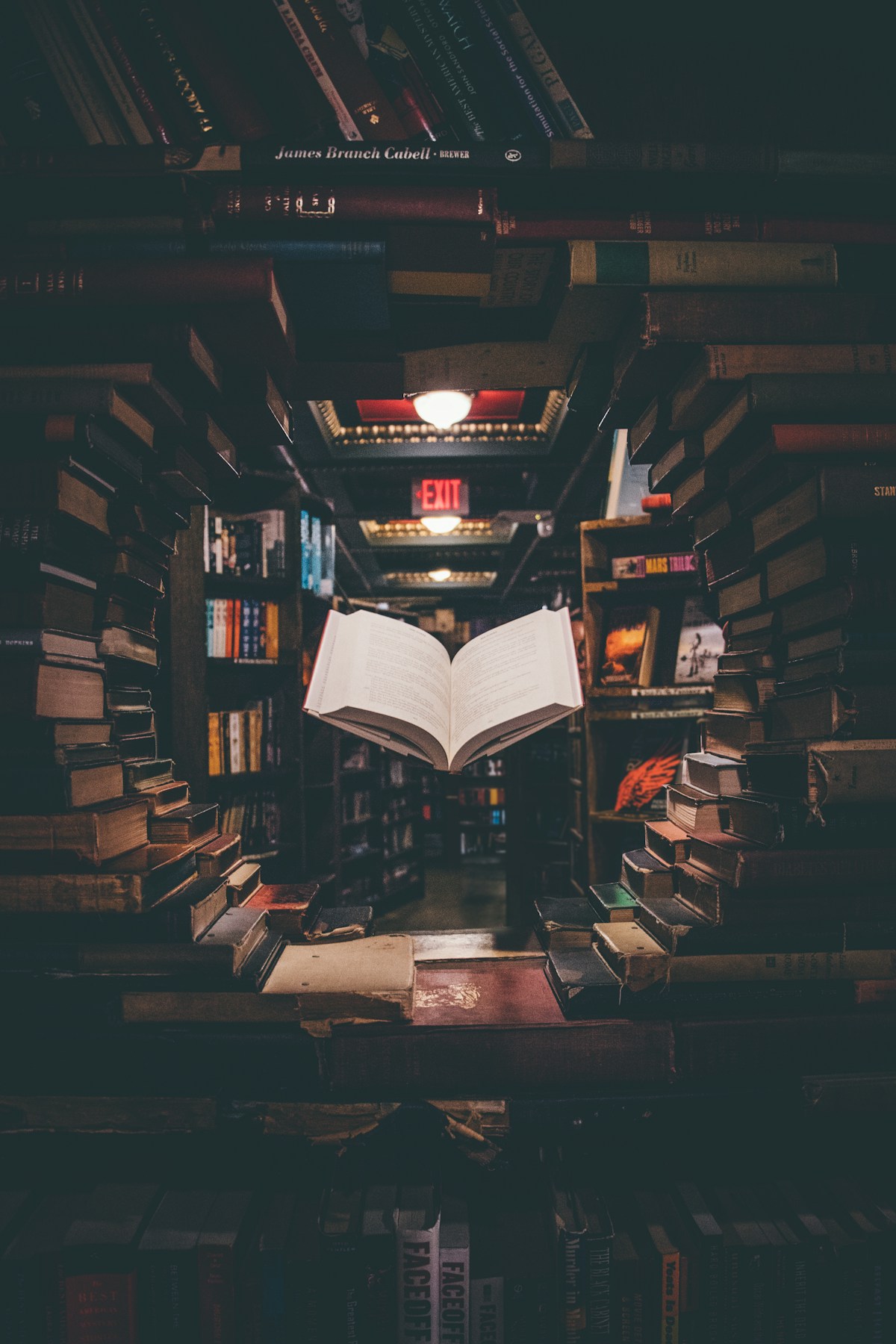 Open books stacked in a library — the dropshipping reading list