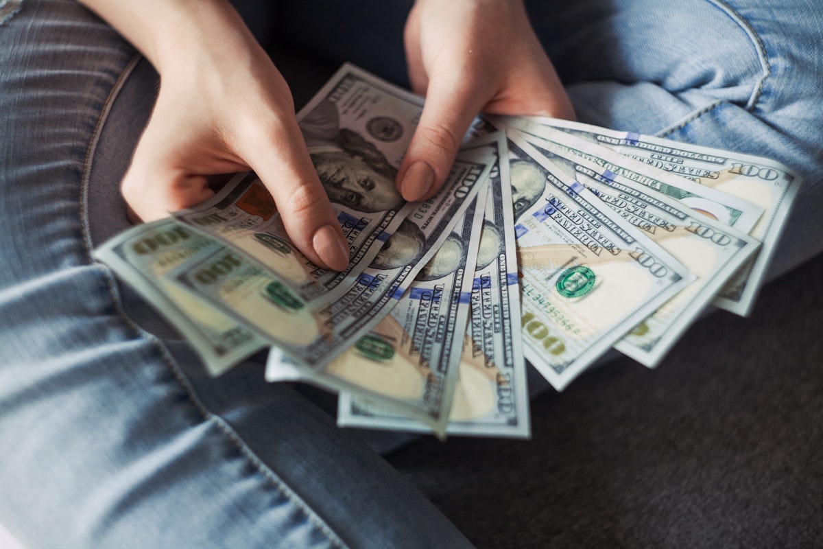 A calculator and cash on a desk — the real cost of starting dropshipping